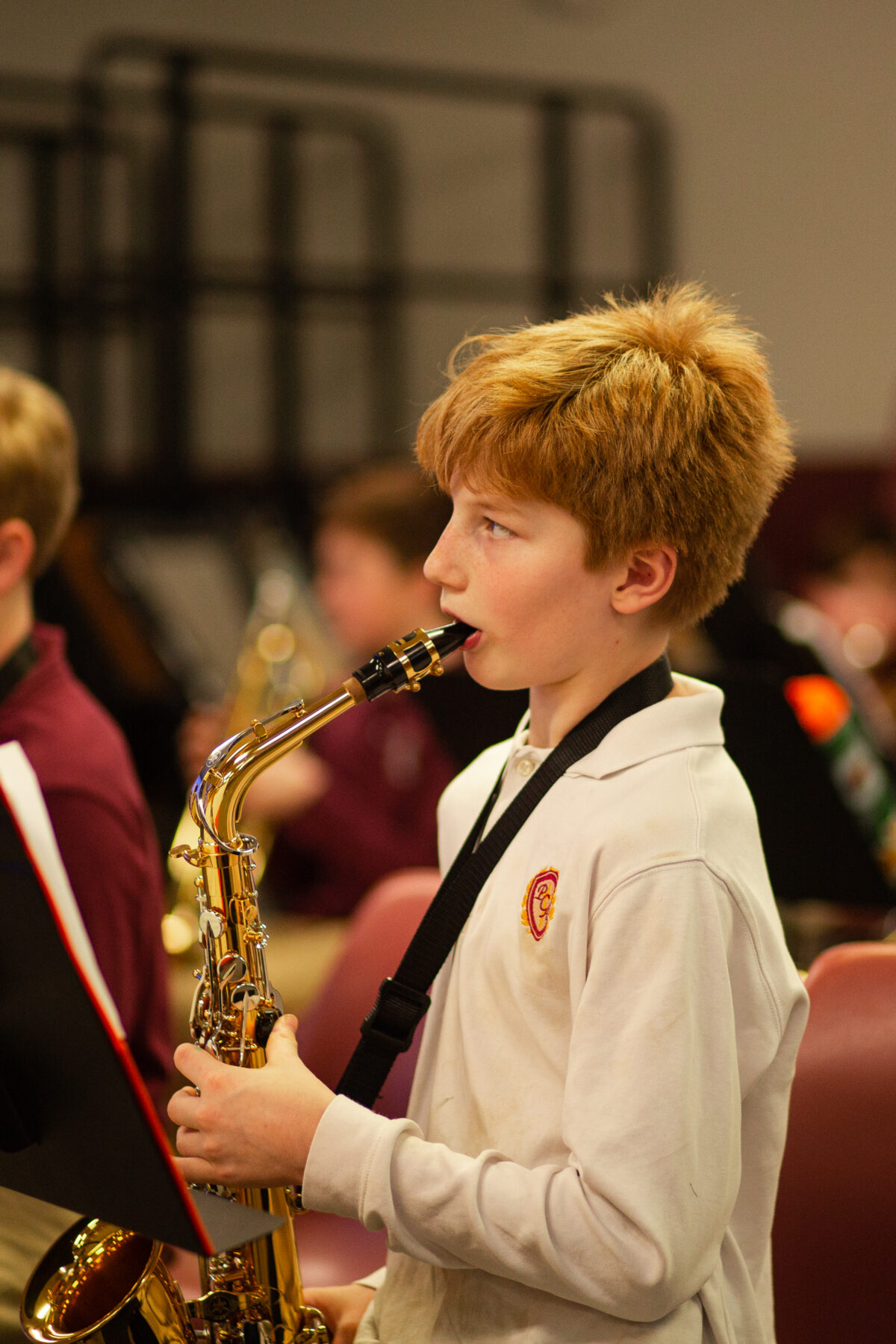 Students playing the saxophone while reading notes