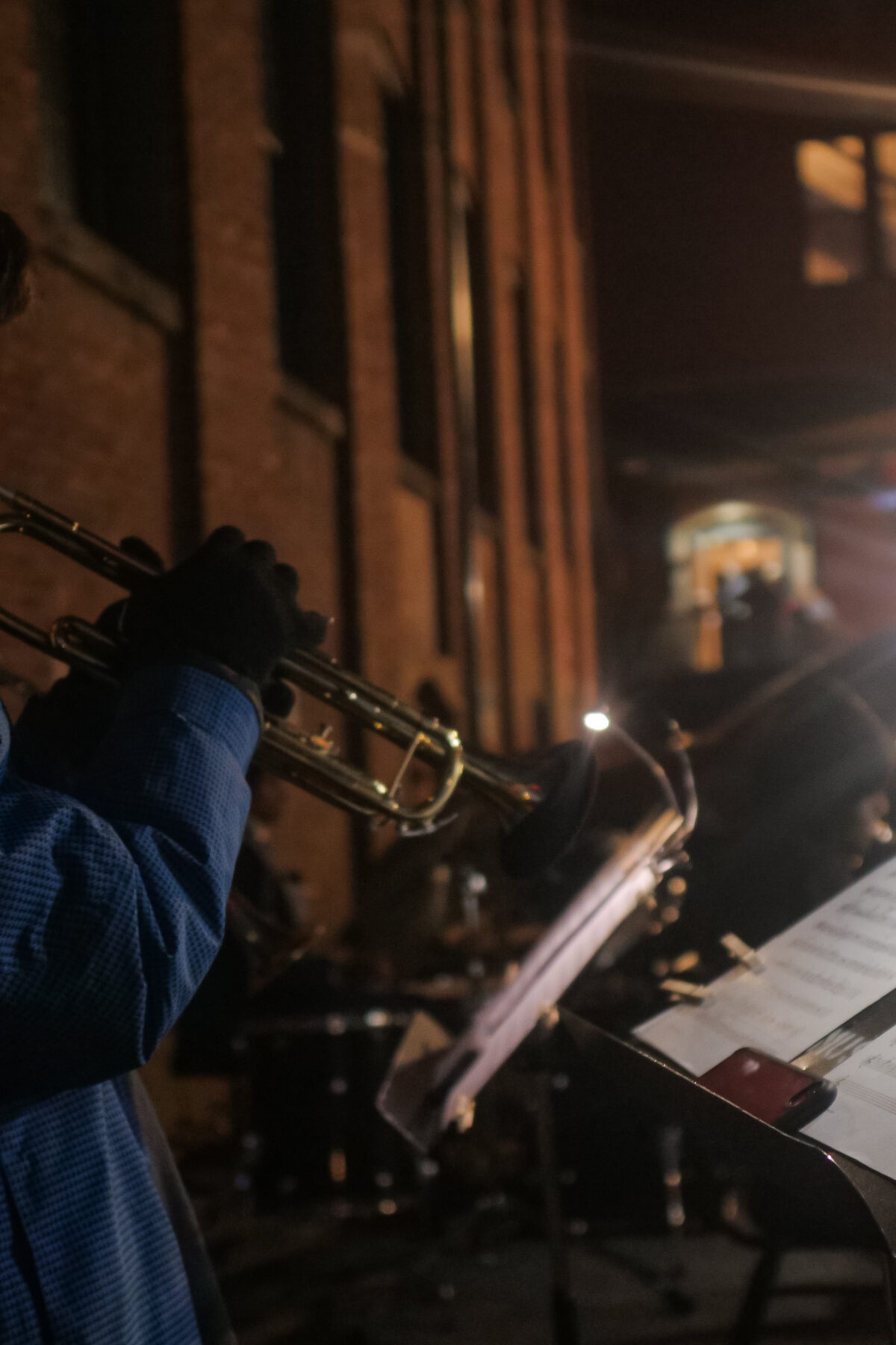 Student playing the trumpet on a winter night