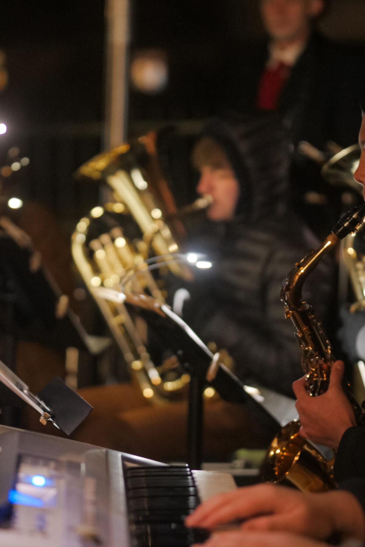 Group of students playing piano, saxophone and horns