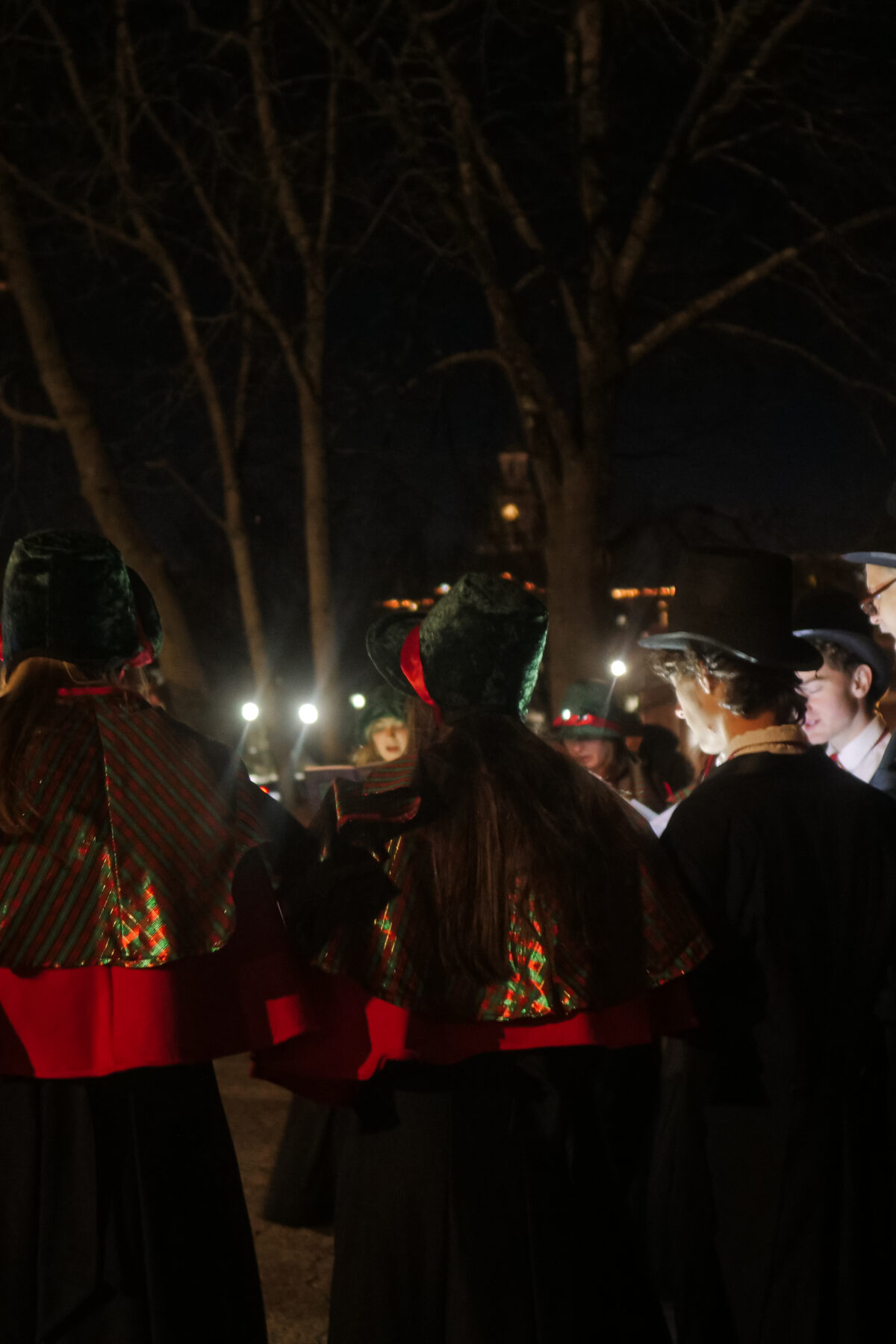 Students with their teacher gathering round to present a Christmas performance