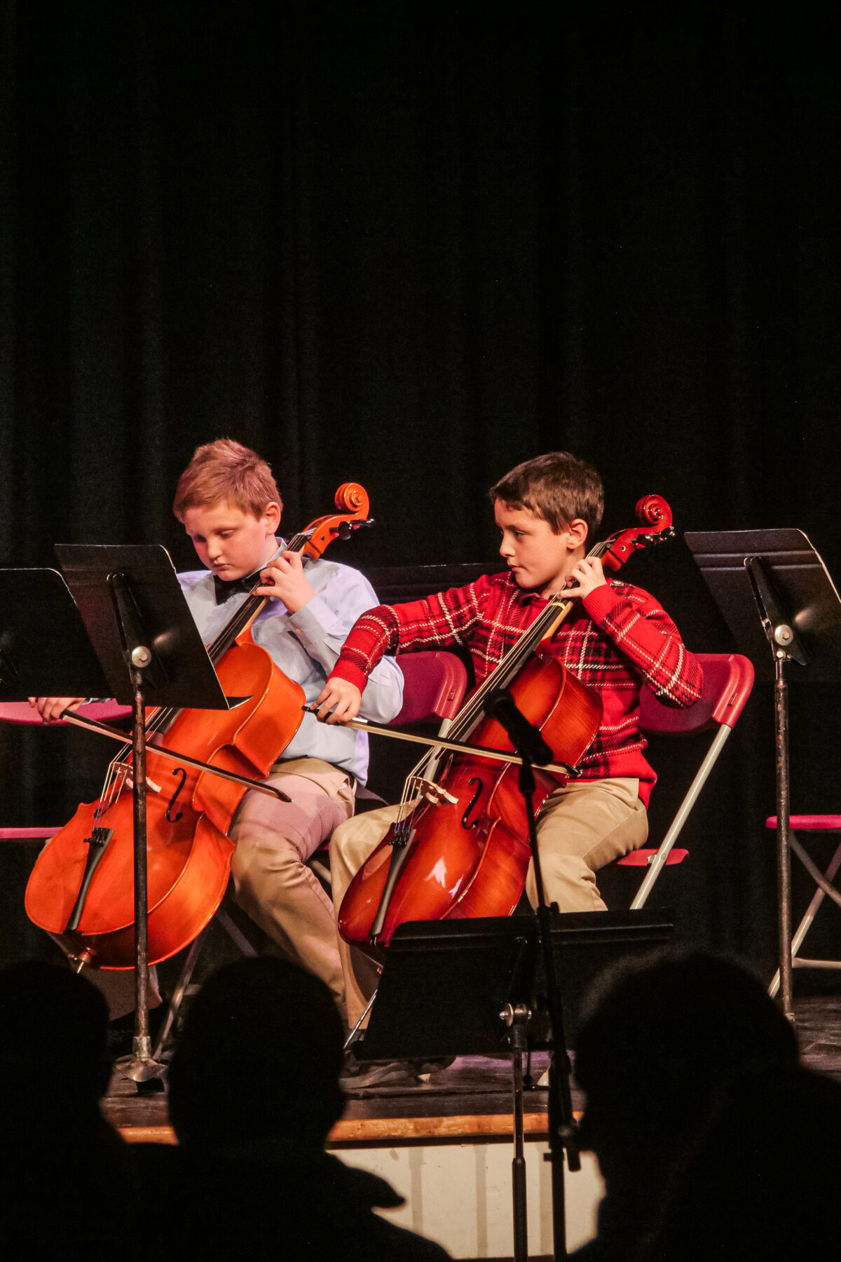 Two students performing and playing the cello