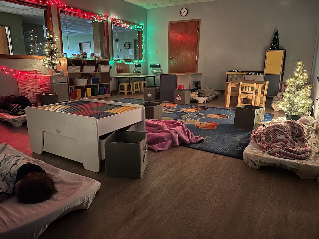 A children's room with a bed and a christmas tree.